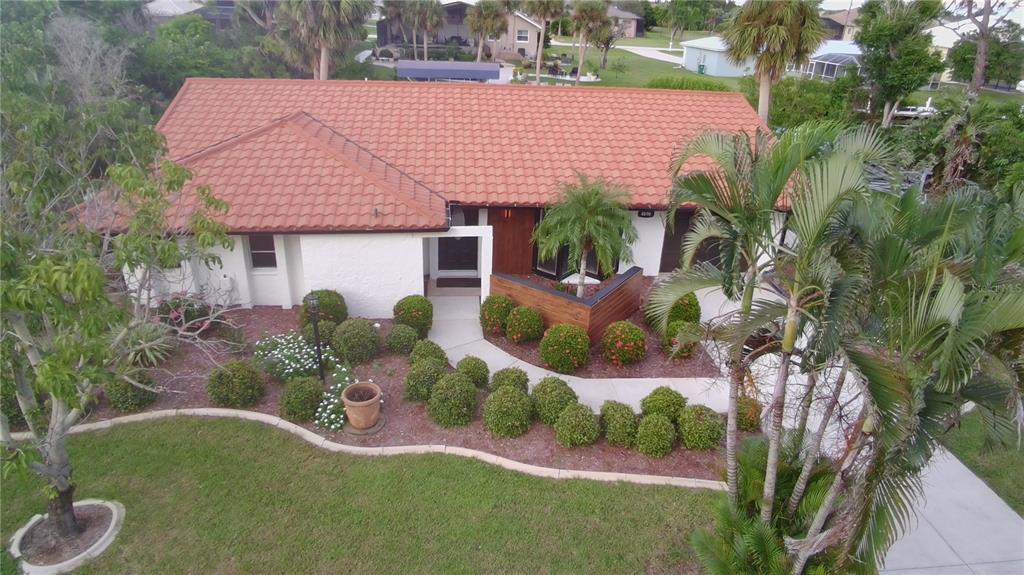 4696 Pompano Street Placida, FL 33946 - Photo 2 of 23 a aerial view of a house with garden