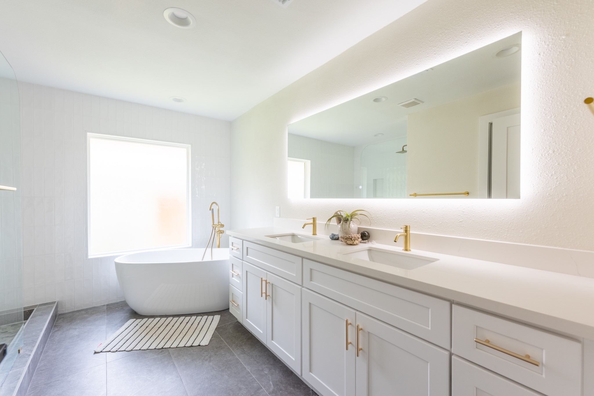 7304 Geneva Drive Austin, TX 78723 - Photo 17 of 39 a bathroom with a bathtub sink vanity and mirror