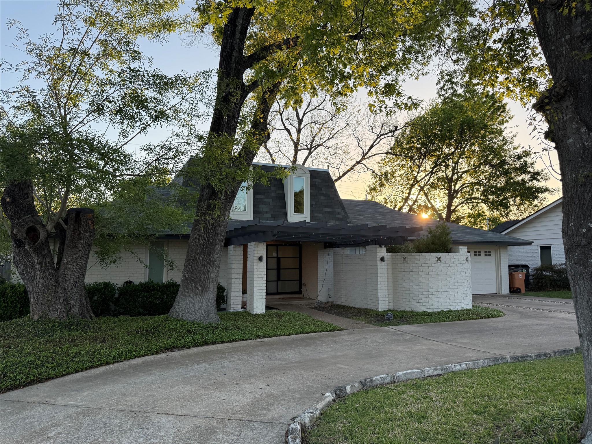 7304 Geneva Drive Austin, TX 78723 - Photo 2 of 39 a view of a white house next to a yard and a large tree