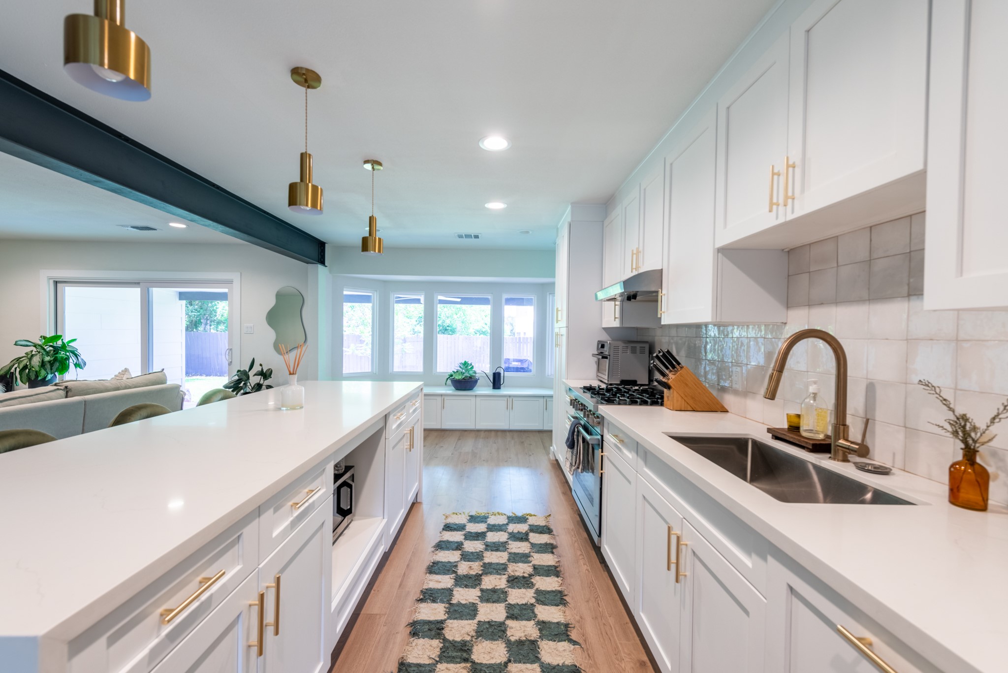 7304 Geneva Drive Austin, TX 78723 - Photo 6 of 39 a large kitchen with a sink and lots of white appliances