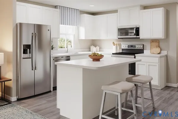 a kitchen with stainless steel appliances a refrigerator stove microwave and sink