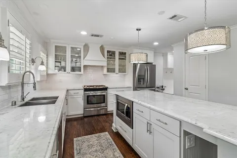 a kitchen with kitchen island granite countertop a sink stainless steel appliances and window
