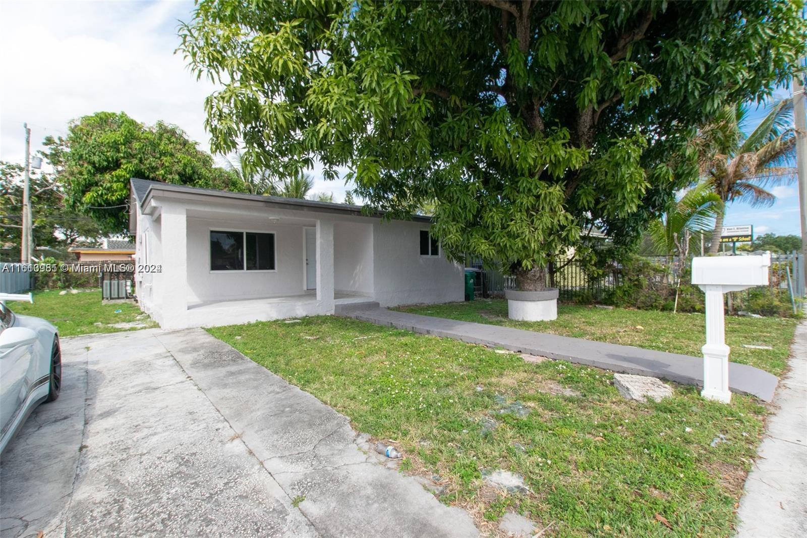 1113 Northwest 103rd Street, Unit 1 Miami, FL 33150 - Photo 2 of 12 a view of a backyard with small cabin