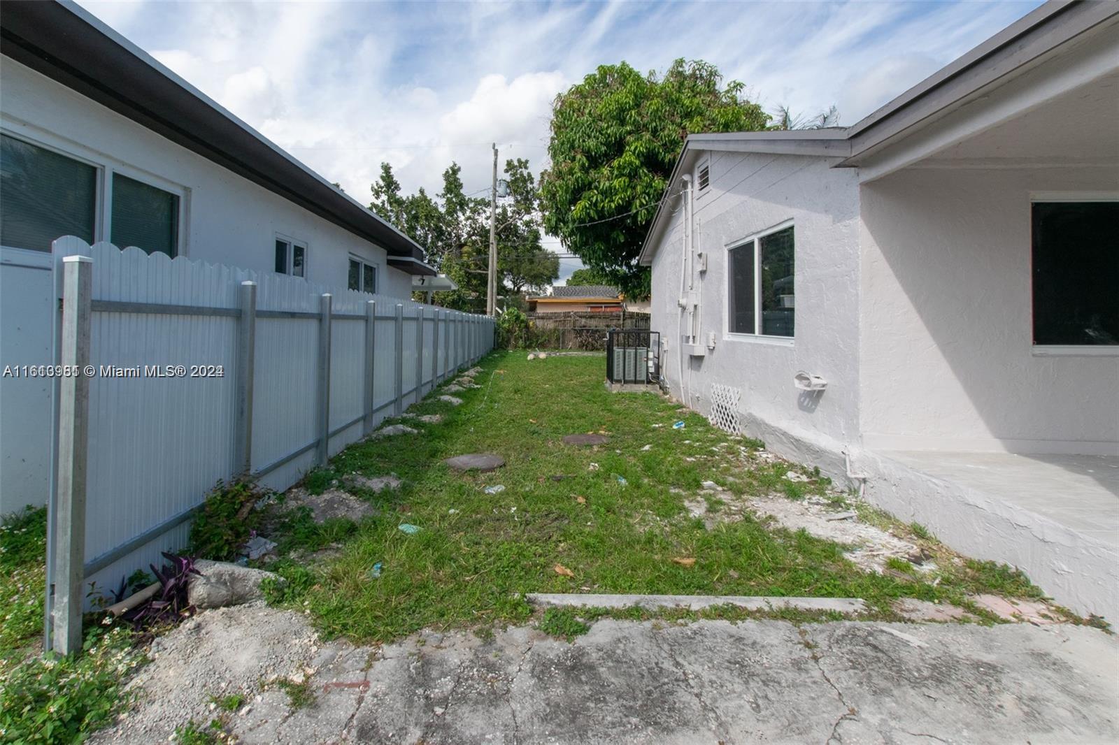 1113 Northwest 103rd Street, Unit 1 Miami, FL 33150 - Photo 3 of 12 a view of a back yard of the house
