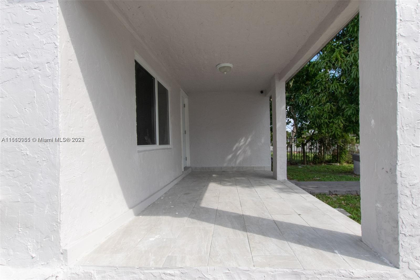 1113 Northwest 103rd Street, Unit 1 Miami, FL 33150 - Photo 4 of 12 front view of a house with a yard