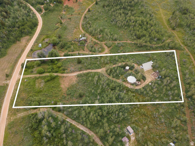 23 Scare Canyon, Unit 23 Logan, UT 84321 - Photo 33 of 33 Aerial view of a sprawling property featuring a main residence, a circular structure, and extensive natural landscaping