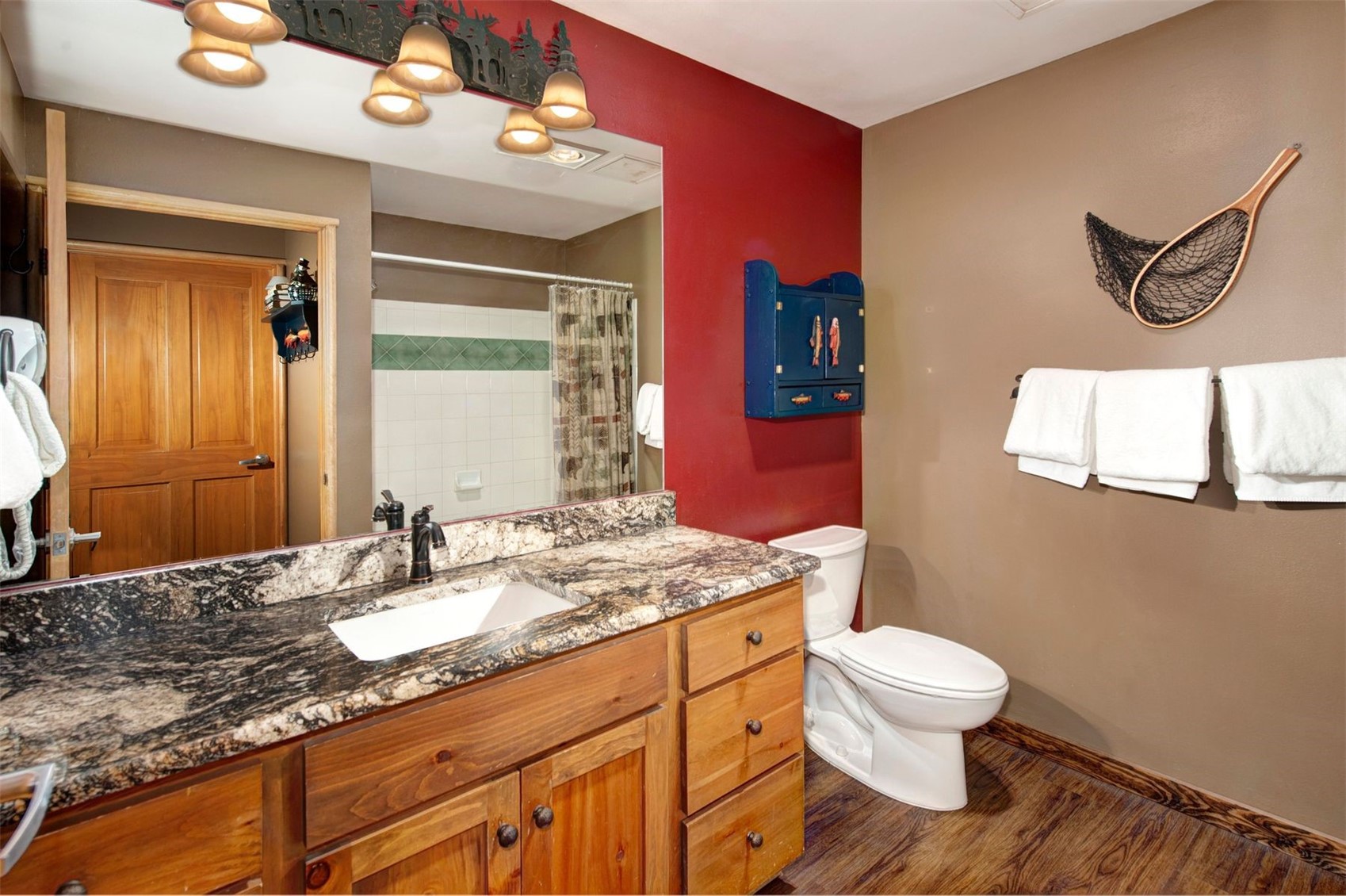 129 River Run Road, Unit 8040 Keystone, CO 80435 - Photo 18 of 50 Full bathroom featuring toilet, vanity, wood finished floors, curtained shower, and baseboards