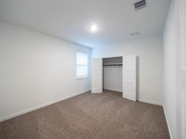 a view of empty room with a fireplace