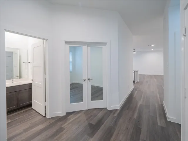 wooden floor in an empty room and a kitchen
