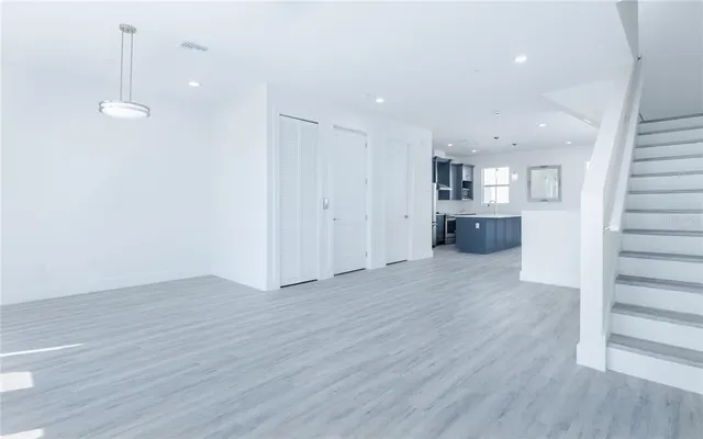 a view of a kitchen with wooden floor and a sink