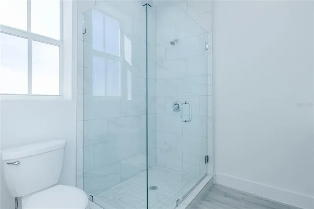 a bathroom with a toilet and a shower