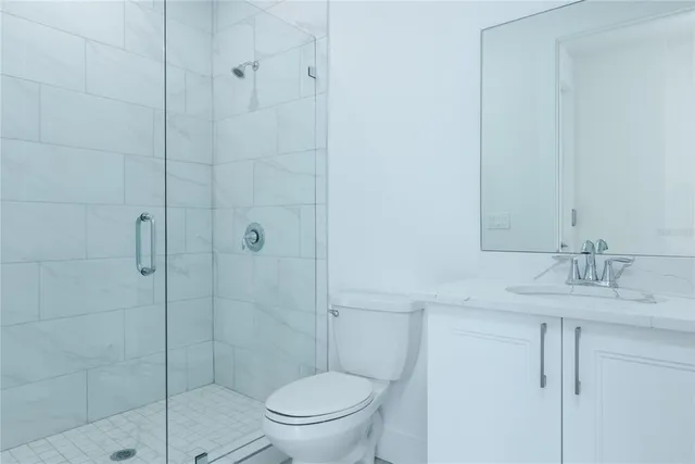 a bathroom with a shower a toilet and sink