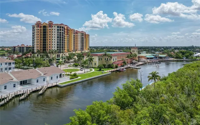 an aerial view of residential houses with outdoor space and lake view