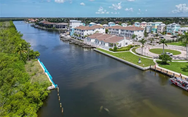 an aerial view of a city with swimming pool and outdoor seating