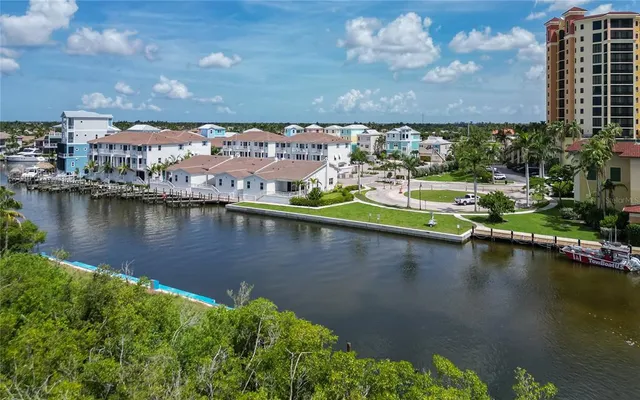 an aerial view of residential houses with outdoor space and lake view