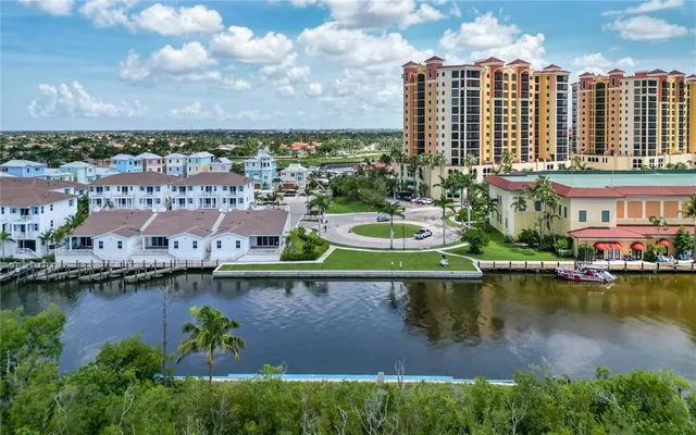 an aerial view of residential building with lake view and boat
