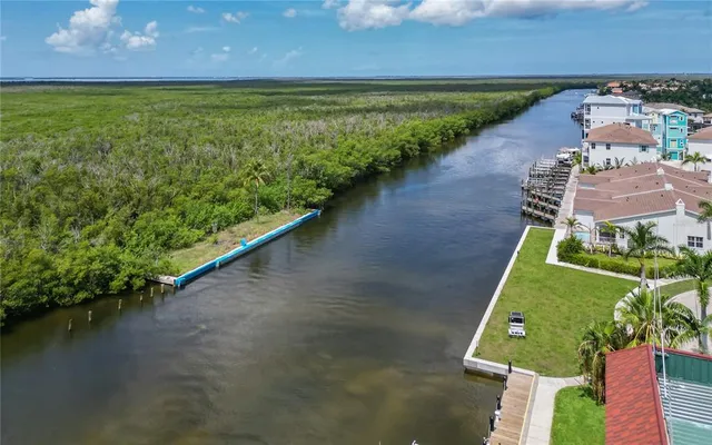 an aerial view of a house with a garden and lake view