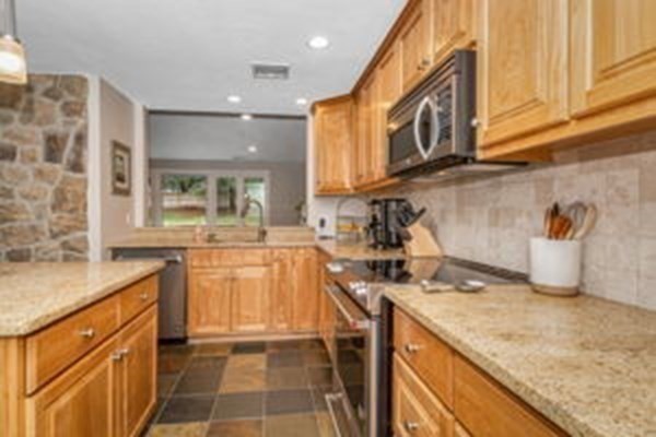 9 Irene Road Framingham, MA 01701 - Photo 11 of 36 a kitchen with stainless steel appliances granite countertop a sink stove and cabinets