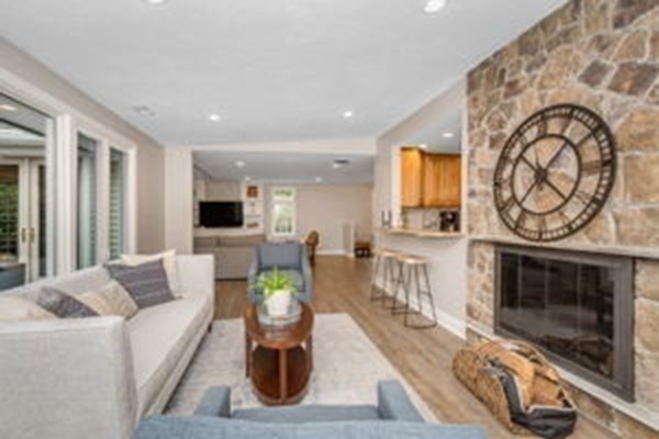 9 Irene Road Framingham, MA 01701 - Photo 12 of 36 a living room with furniture a fireplace and a flat screen tv