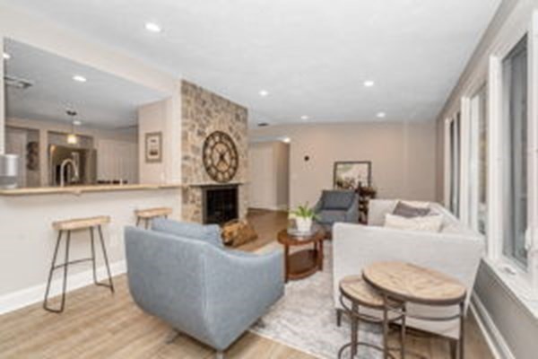 9 Irene Road Framingham, MA 01701 - Photo 13 of 36 a living room with fireplace furniture and a wooden floor