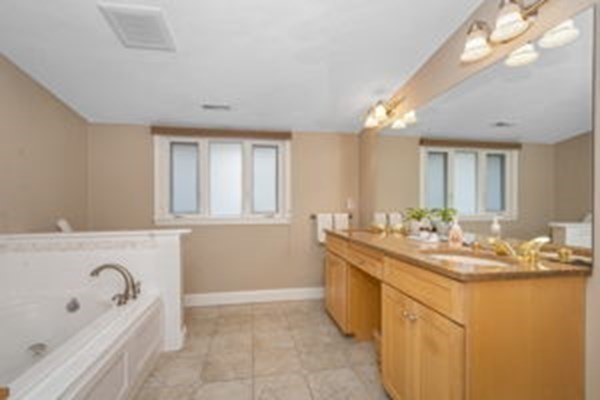 9 Irene Road Framingham, MA 01701 - Photo 23 of 36 a bathroom with a tub sink and mirror