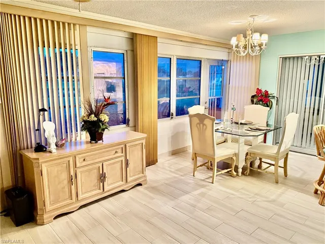 a view of a dining room with furniture and chandelier