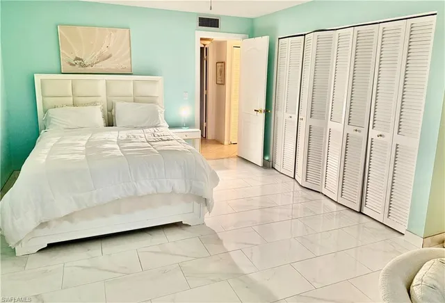 a bedroom with a bed and a shower