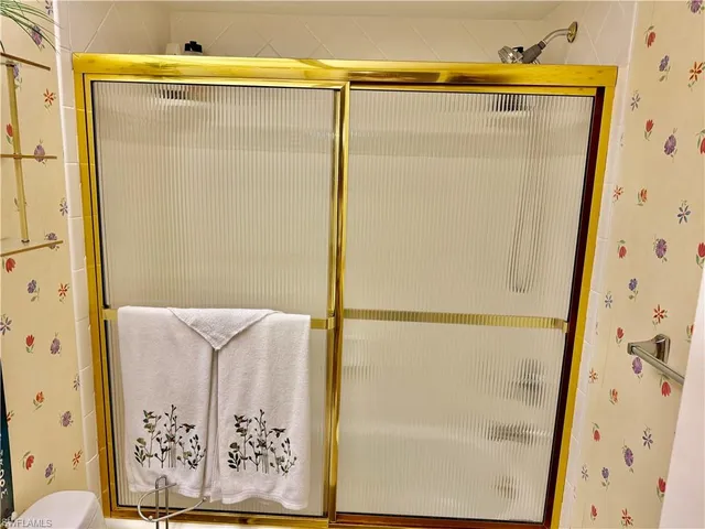 a bathroom with a shower and a tub