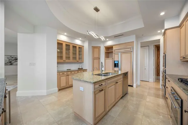 a large kitchen with a stove and a sink