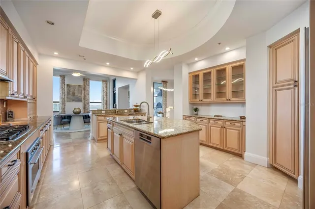 a large kitchen with stainless steel appliances granite countertop a stove and a sink