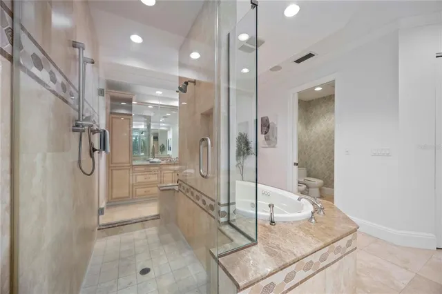 a white toilet sitting next to a shower