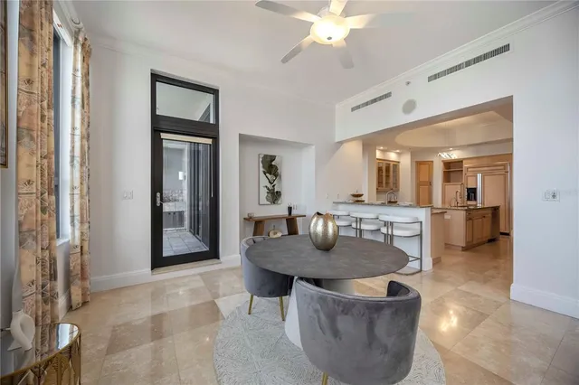 a dining room with furniture and a chandelier