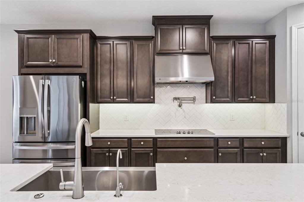 3351 Current Avenue Winter Garden, FL 34787 - Photo 18 of 63 a kitchen with stainless steel appliances granite countertop a refrigerator and a stove top oven