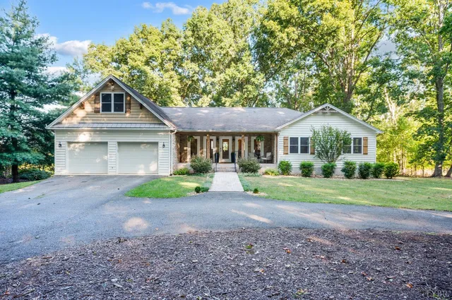 a front view of a house with yard and green space