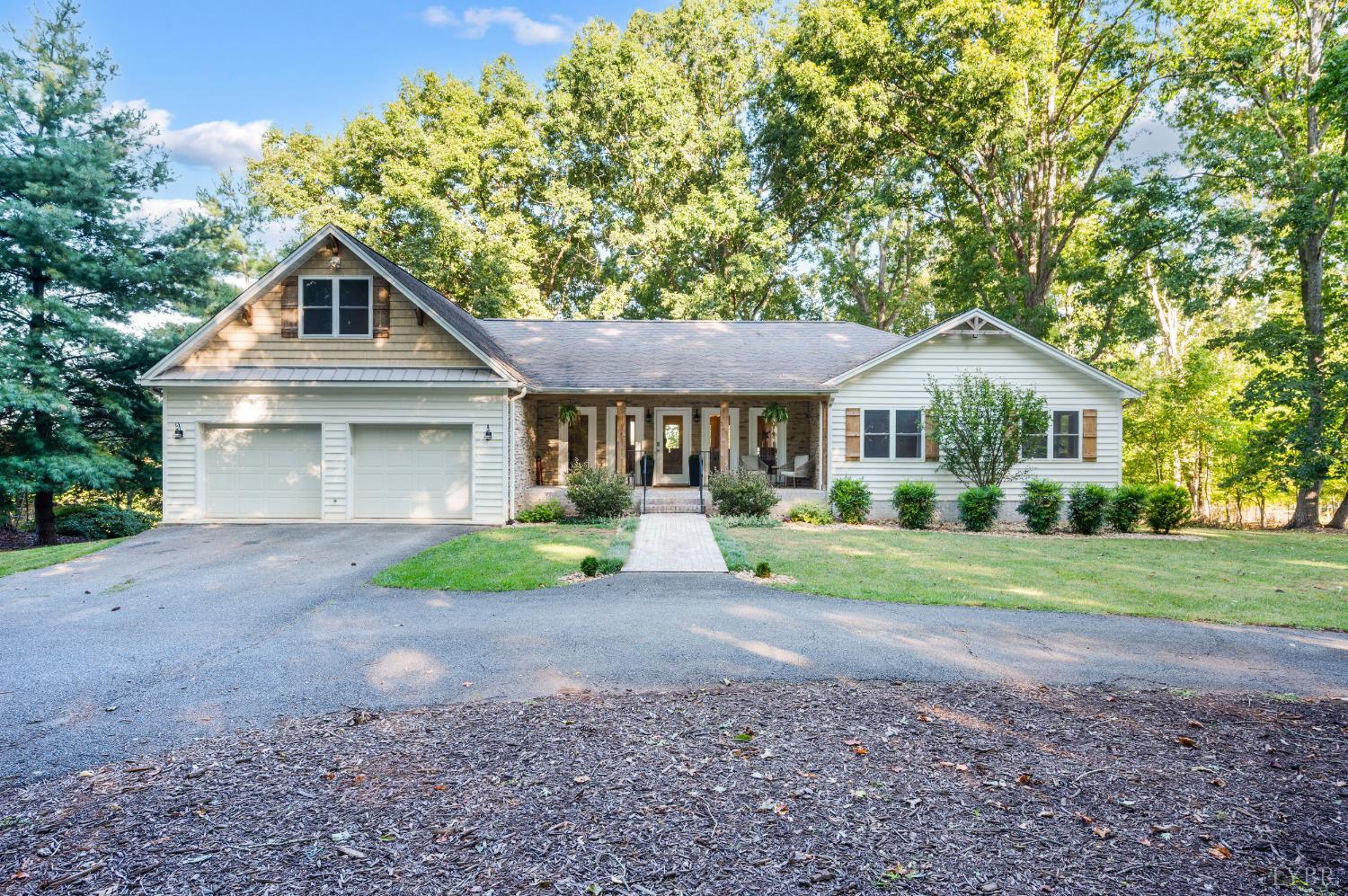 a front view of a house with yard and green space