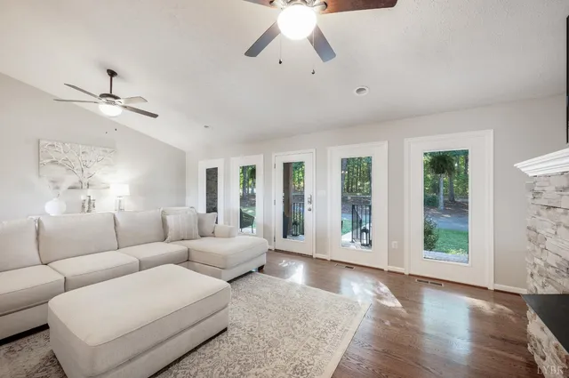 a living room with furniture ceiling fan and a window