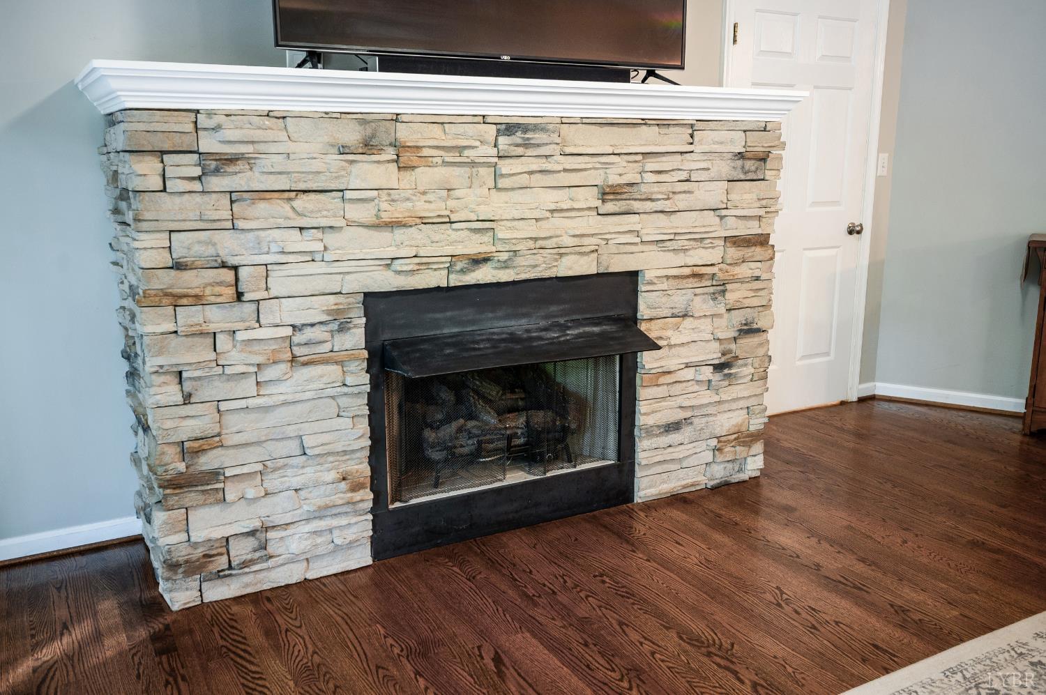 1203 Everett Road Forest, VA 24551 - Photo 12 of 68 a room with fireplace and wooden floor