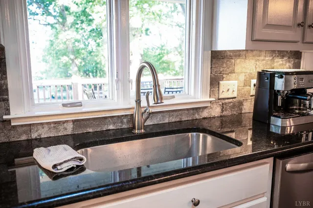 a view of a bedroom with wooden floor and window