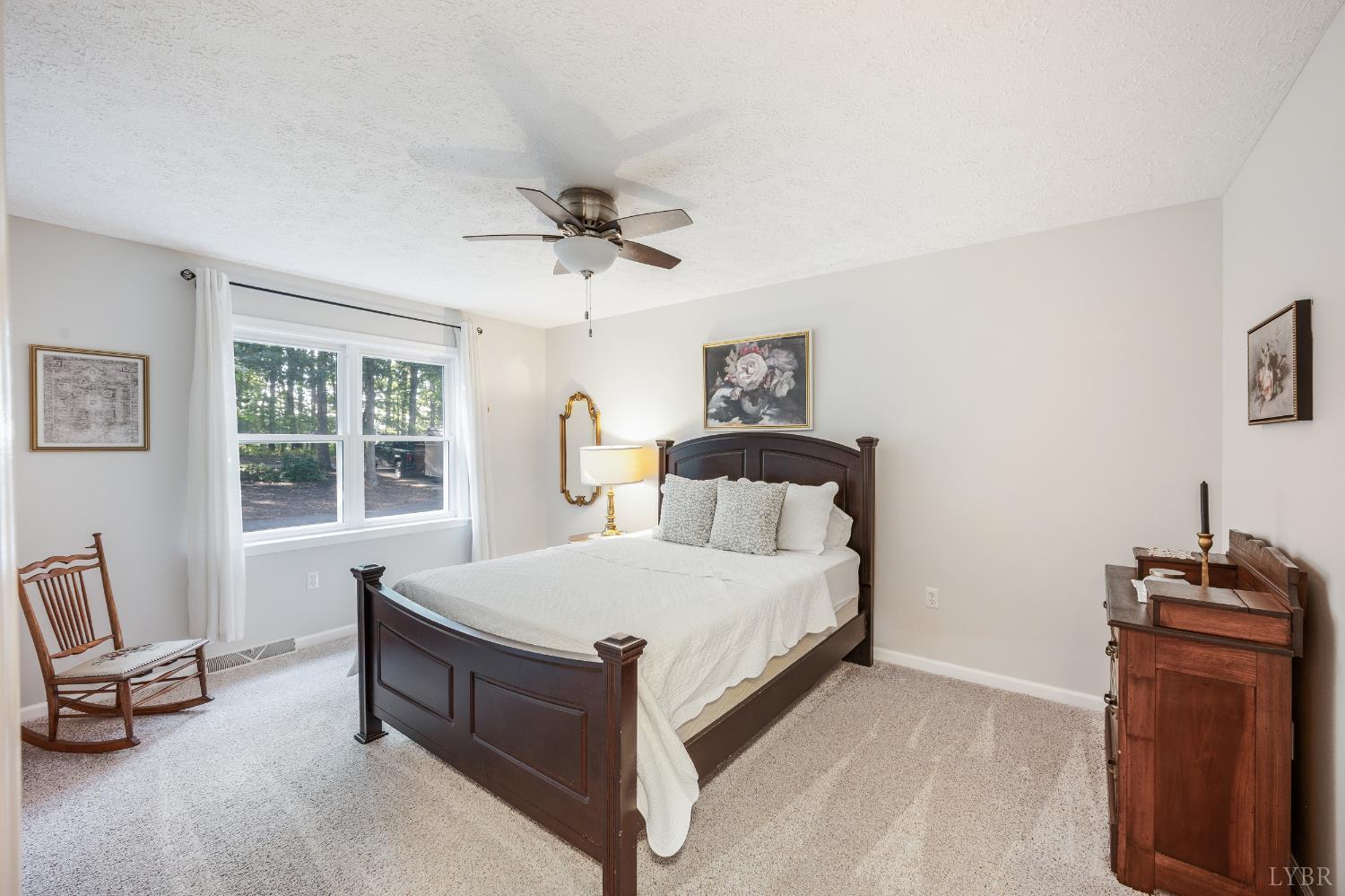 1203 Everett Road Forest, VA 24551 - Photo 29 of 68 a spacious bedroom with a bed and a couch