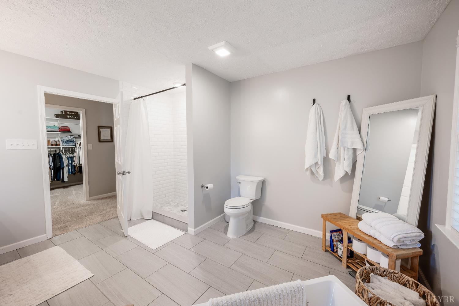 1203 Everett Road Forest, VA 24551 - Photo 32 of 68 a spacious bathroom with a bathtub and a toilet