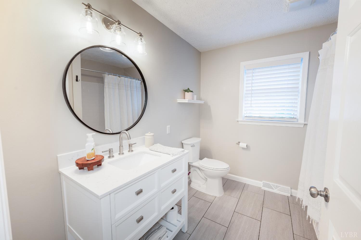 1203 Everett Road Forest, VA 24551 - Photo 36 of 68 a bathroom with a sink and a mirror