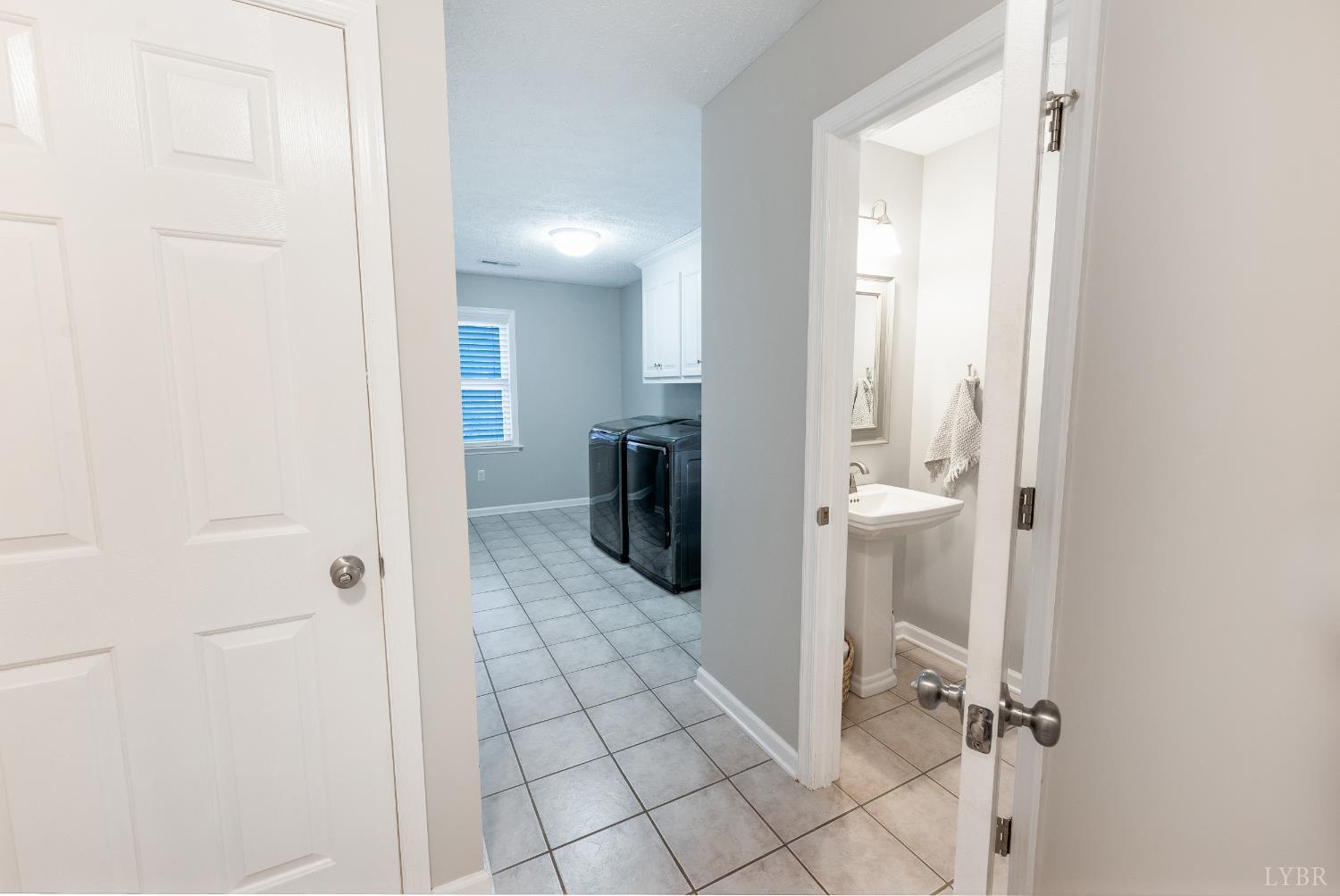 1203 Everett Road Forest, VA 24551 - Photo 39 of 68 a view of a livingroom with wooden floor and a bathroom space