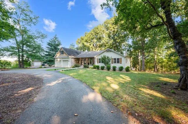 a front view of house with yard and green space