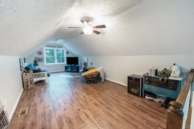 a view of backyard with deck and wooden floor