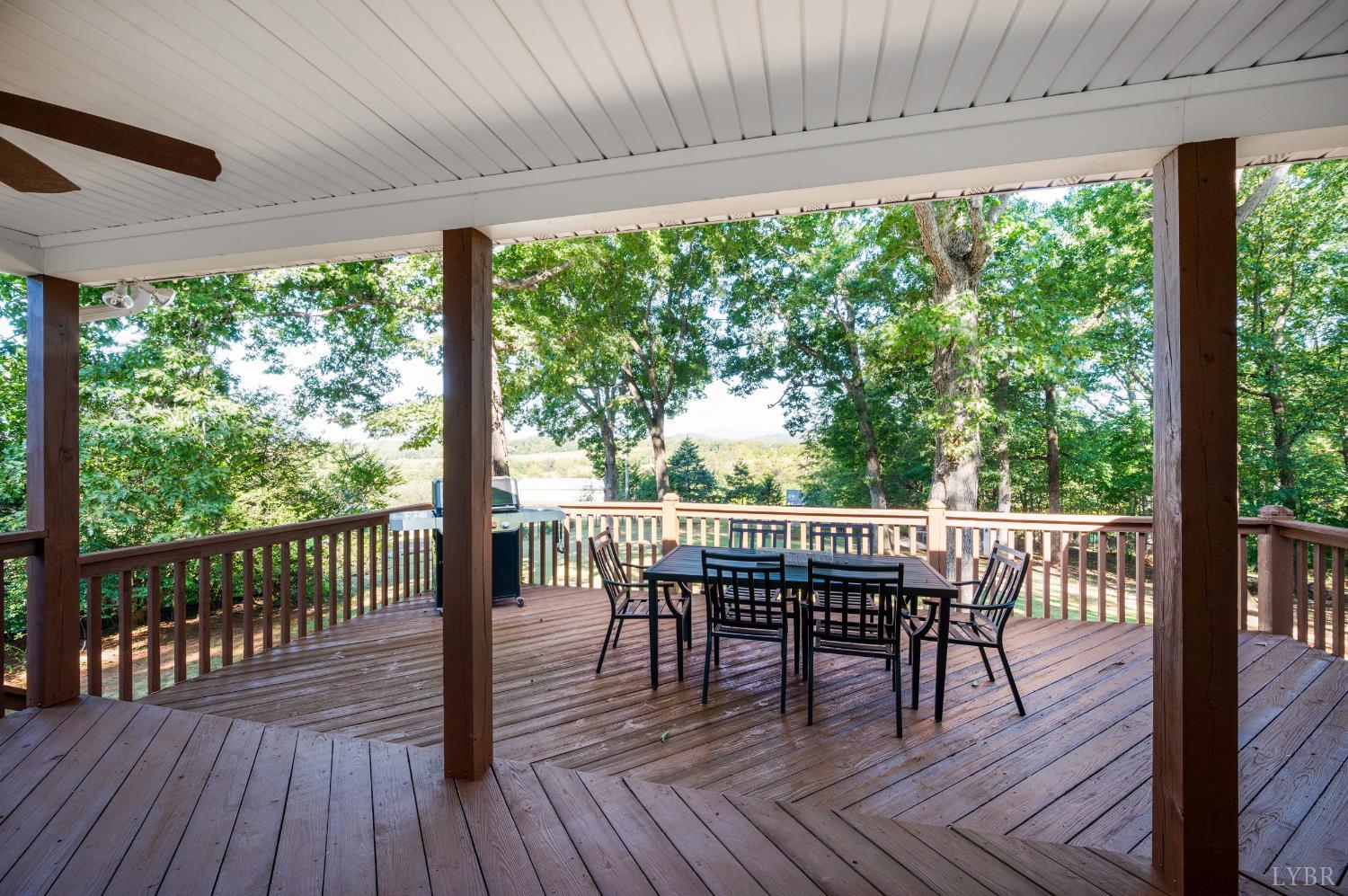 1203 Everett Road Forest, VA 24551 - Photo 56 of 68 a view of a patio with a table chairs and wooden floor