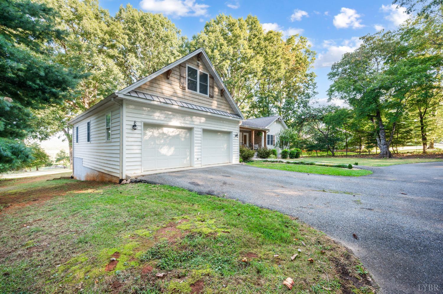 1203 Everett Road Forest, VA 24551 - Photo 64 of 68 a front view of a house with a yard and garage