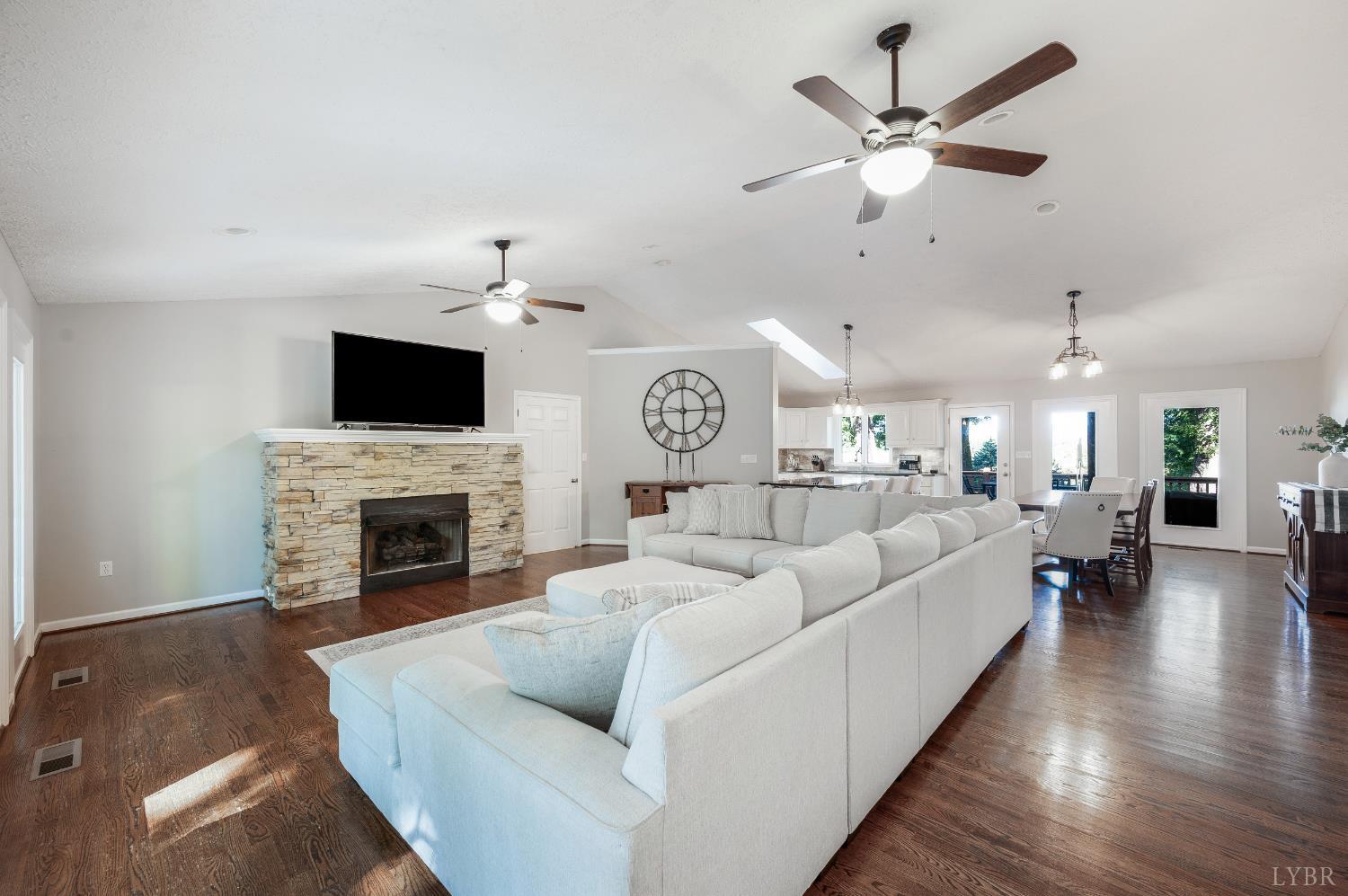 1203 Everett Road Forest, VA 24551 - Photo 9 of 68 a living room with furniture a fireplace and a flat screen tv