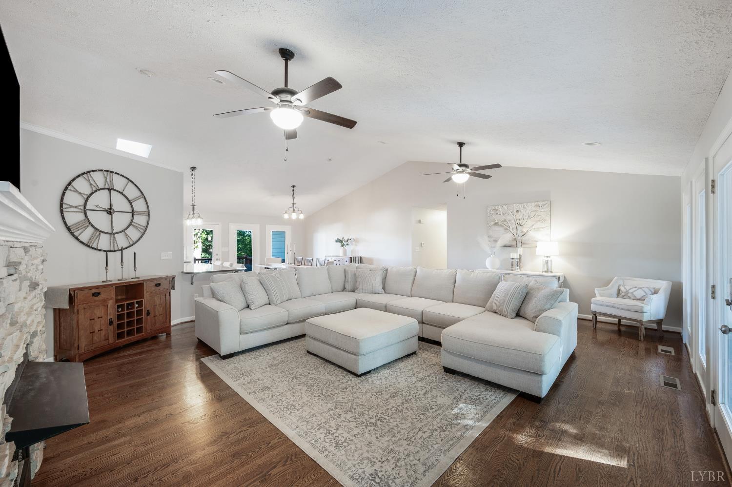 1203 Everett Road Forest, VA 24551 - Photo 10 of 68 a living room with furniture a clock and a ceiling fan