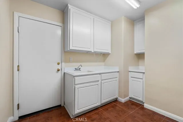 a utility room with cabinets washer and dryer
