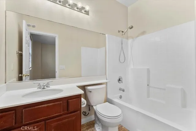a bathroom with a sink toilet vanity and shower